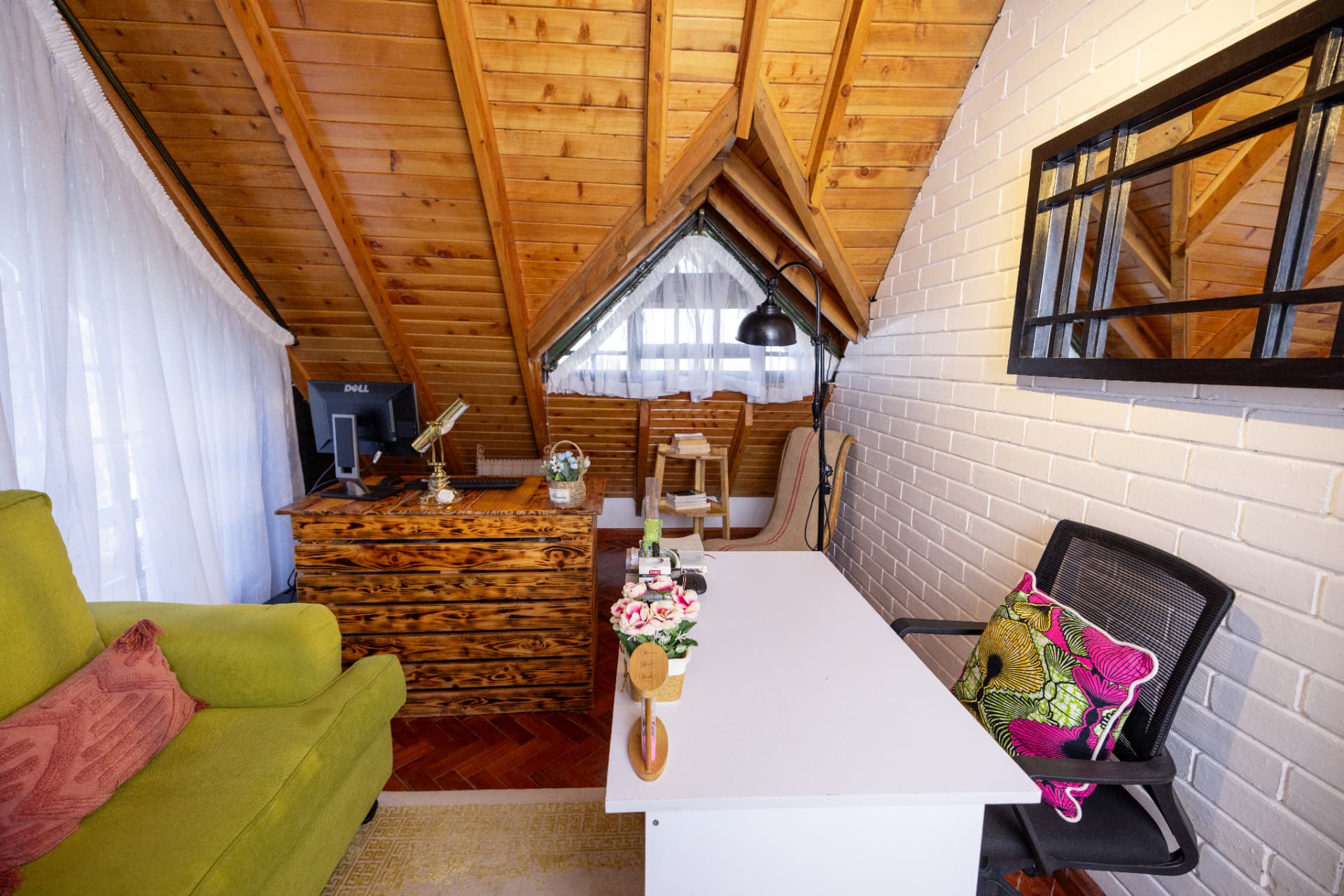 Yaara Design Studio's loft workspace with pitched timber ceiling, whitewashed brick and reclaimed pine desk